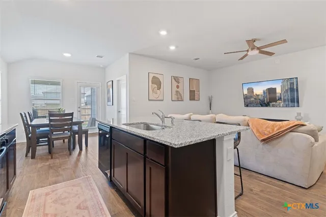 a living room with granite countertop furniture and a dining table