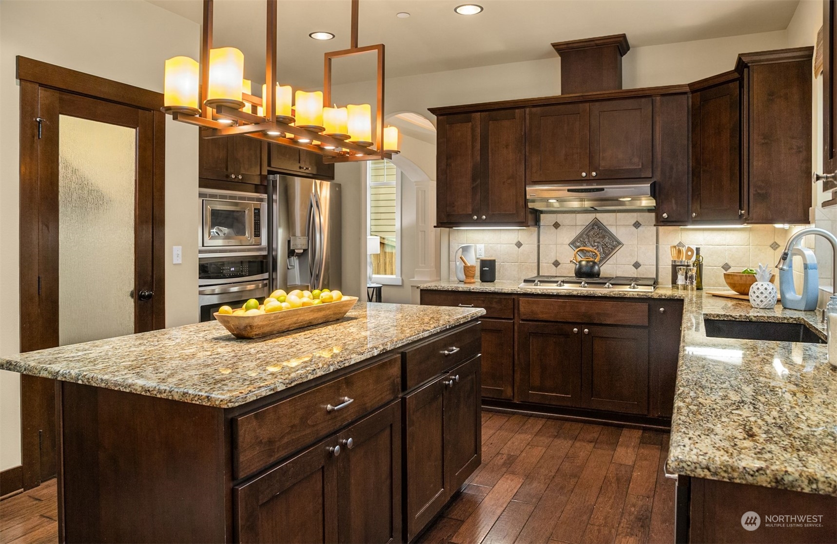 21710 31st Drive Southeast Bothell, WA 98021 - Photo 12 of 35 a kitchen with granite countertop kitchen island stainless steel appliances a sink stove and refrigerator
