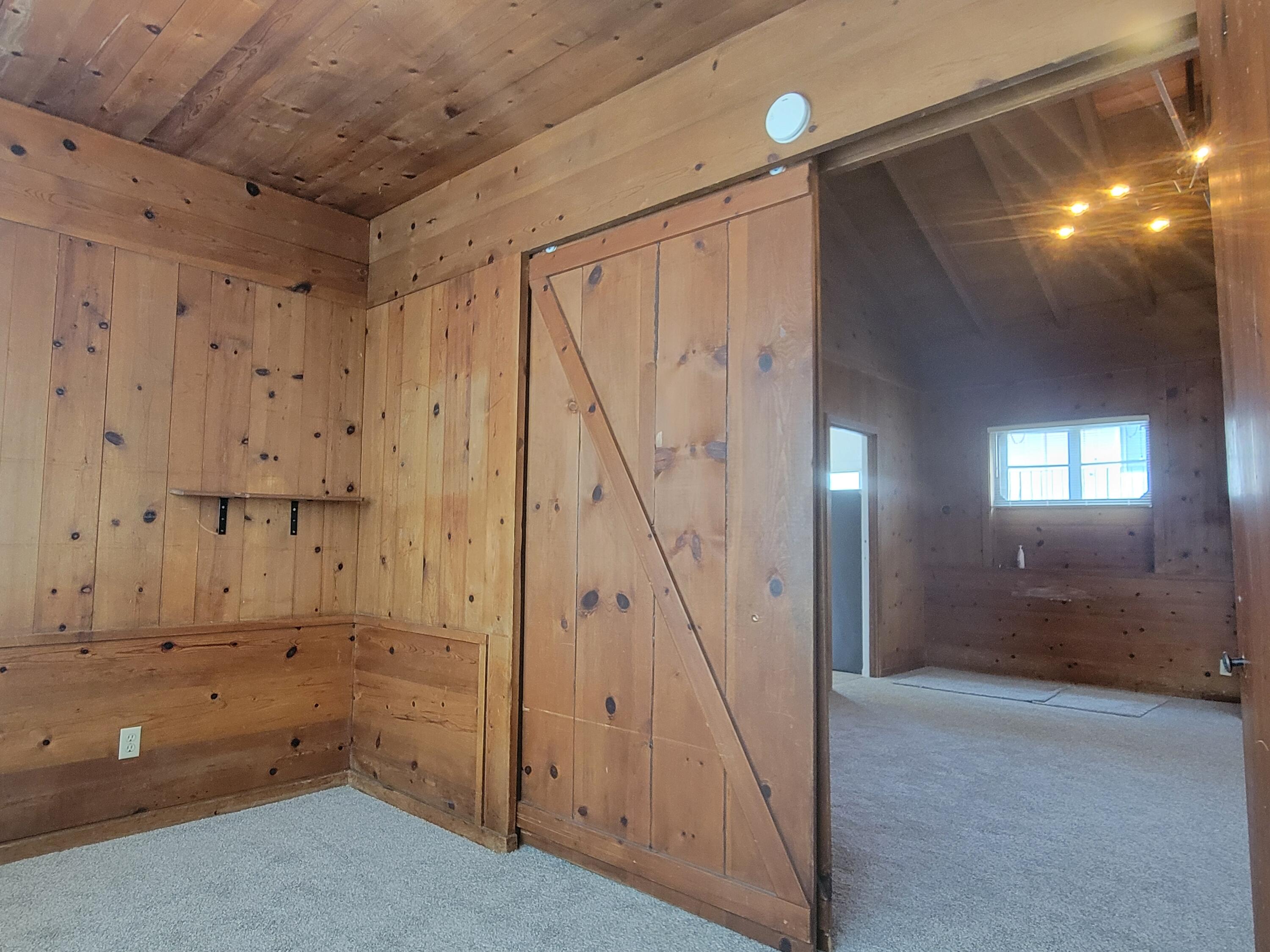 219 Ladera Street, Unit 1 Santa Barbara, CA 93101 - Photo 4 of 9 an empty room with wooden floor and windows