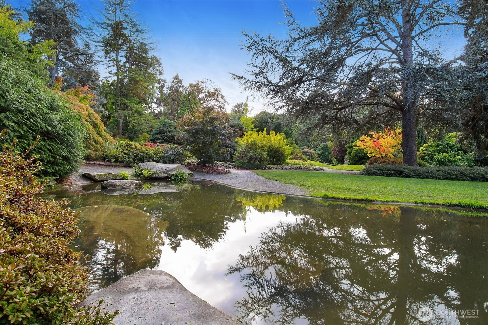 5126 South Garden Loop Road, Unit 11 Seattle, WA 98118 - Photo 35 of 36 a view of a lake with a yard