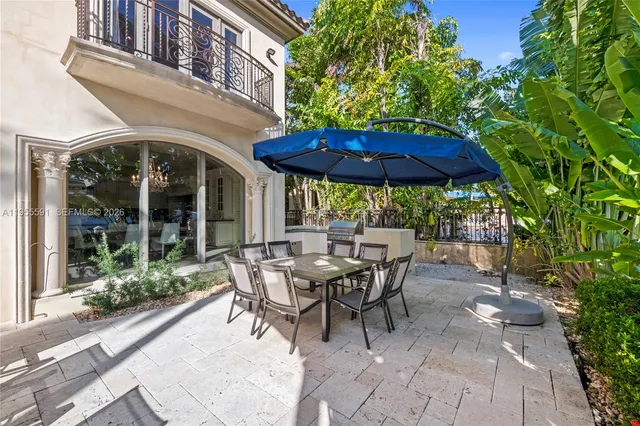 a living room with furniture a fireplace and a chandelier
