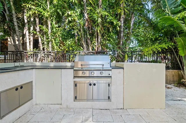 a living room with furniture a fireplace and a chandelier