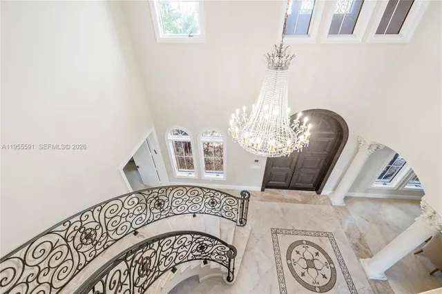a living room with fireplace furniture and a large window