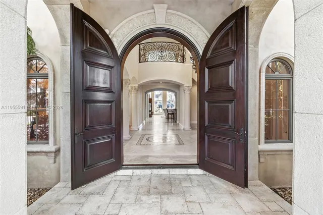 a kitchen with stainless steel appliances granite countertop a stove a kitchen island a dining table and chairs