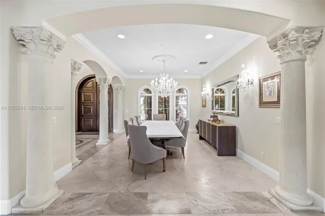 a spacious bedroom with a bed and a chandelier
