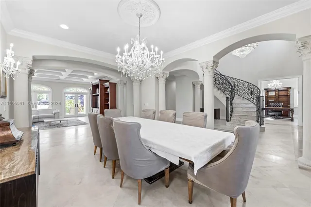 a spacious bedroom with a large bed and a chandelier