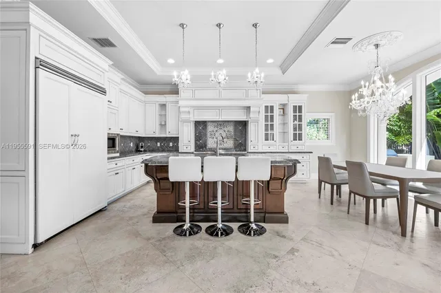 a bedroom with a bed lamp and large window