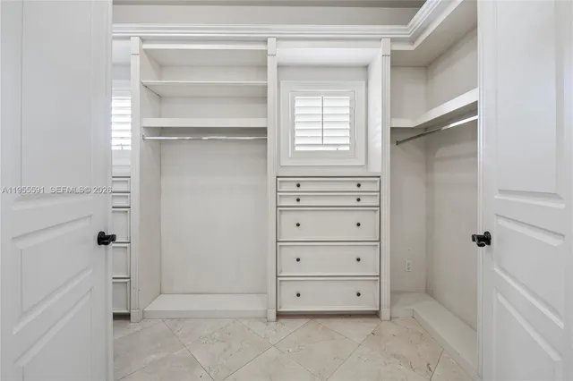 a bathroom with a granite countertop sink toilet mirror vanity and shower