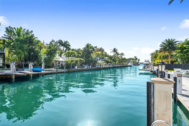 a view of a entryway door with flower pot and a potted plant