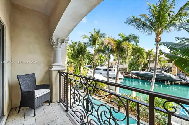 a view of a patio with table and chairs under an umbrella