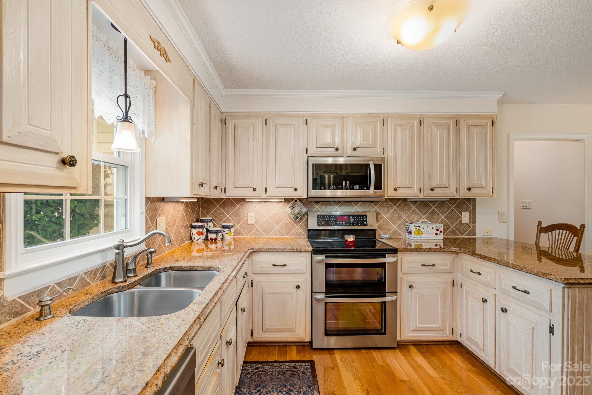 8229 Fairfield Forest Road Denver, NC 28037 - Photo 14 of 41 a kitchen with stainless steel appliances granite countertop a sink and a stove