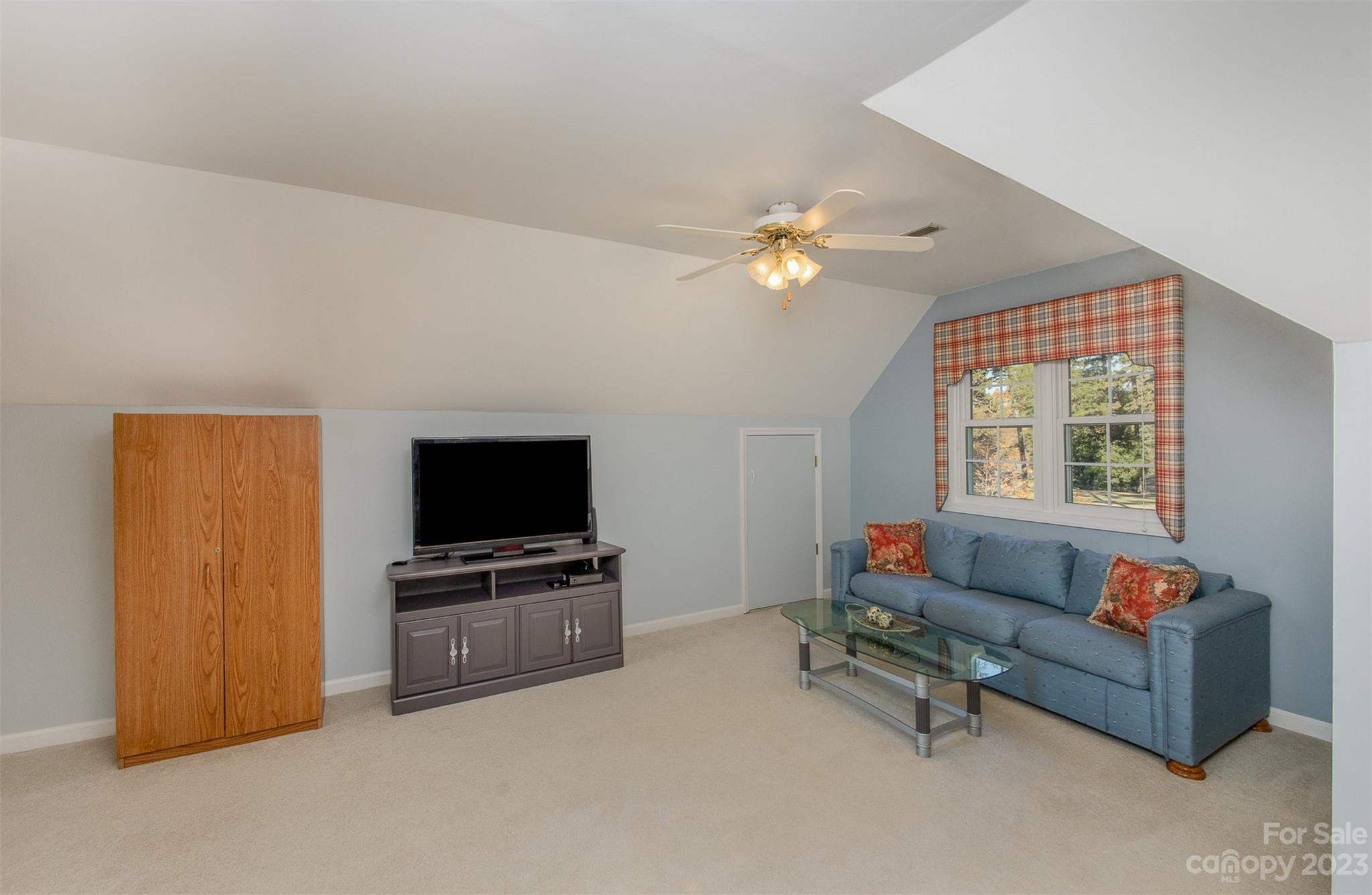 8229 Fairfield Forest Road Denver, NC 28037 - Photo 36 of 41 a living room with furniture and a flat screen tv