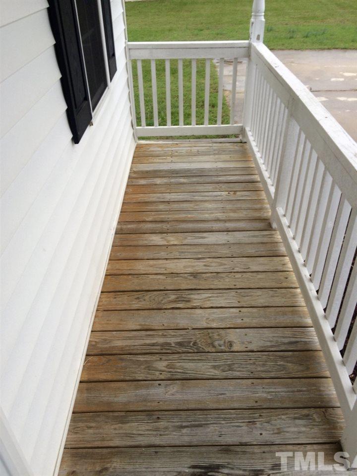 258 Wagner Road Willow Spring, NC 27592 - Photo 2 of 22 a view of balcony with wooden floor and fence