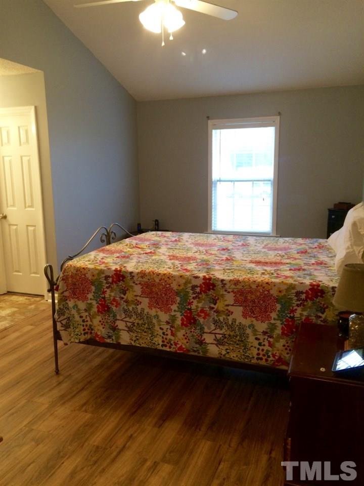 258 Wagner Road Willow Spring, NC 27592 - Photo 11 of 22 a bedroom with a bed and a window