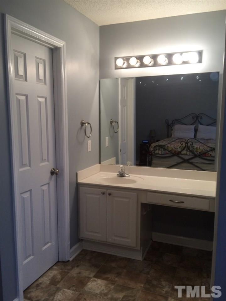 258 Wagner Road Willow Spring, NC 27592 - Photo 13 of 22 a bathroom with a sink and mirror
