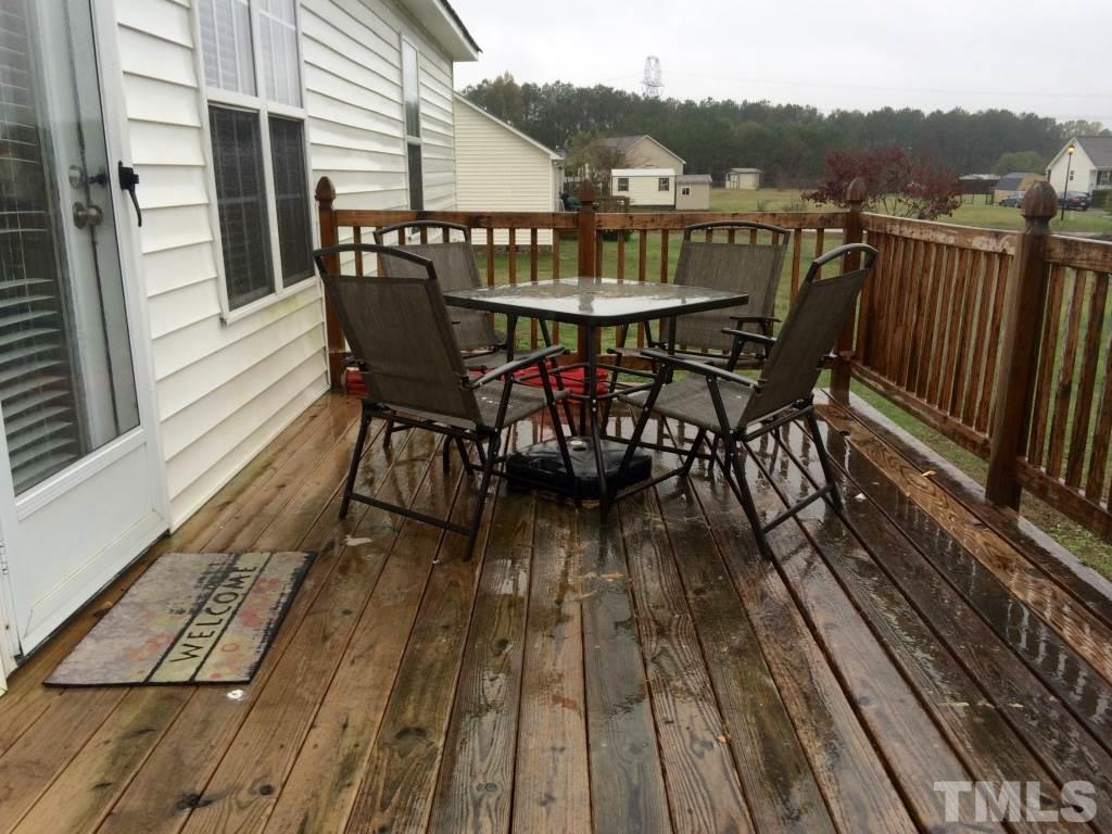 258 Wagner Road Willow Spring, NC 27592 - Photo 19 of 22 a view of a chairs on wooden deck