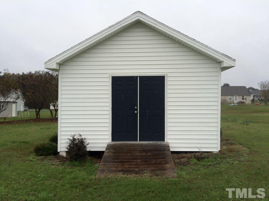 258 Wagner Road Willow Spring, NC 27592 - Photo 21 of 22 a view of a house with a yard