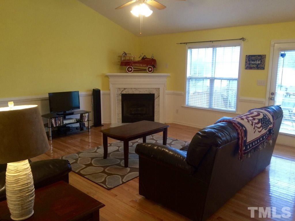 258 Wagner Road Willow Spring, NC 27592 - Photo 4 of 22 a living room with furniture and a fireplace