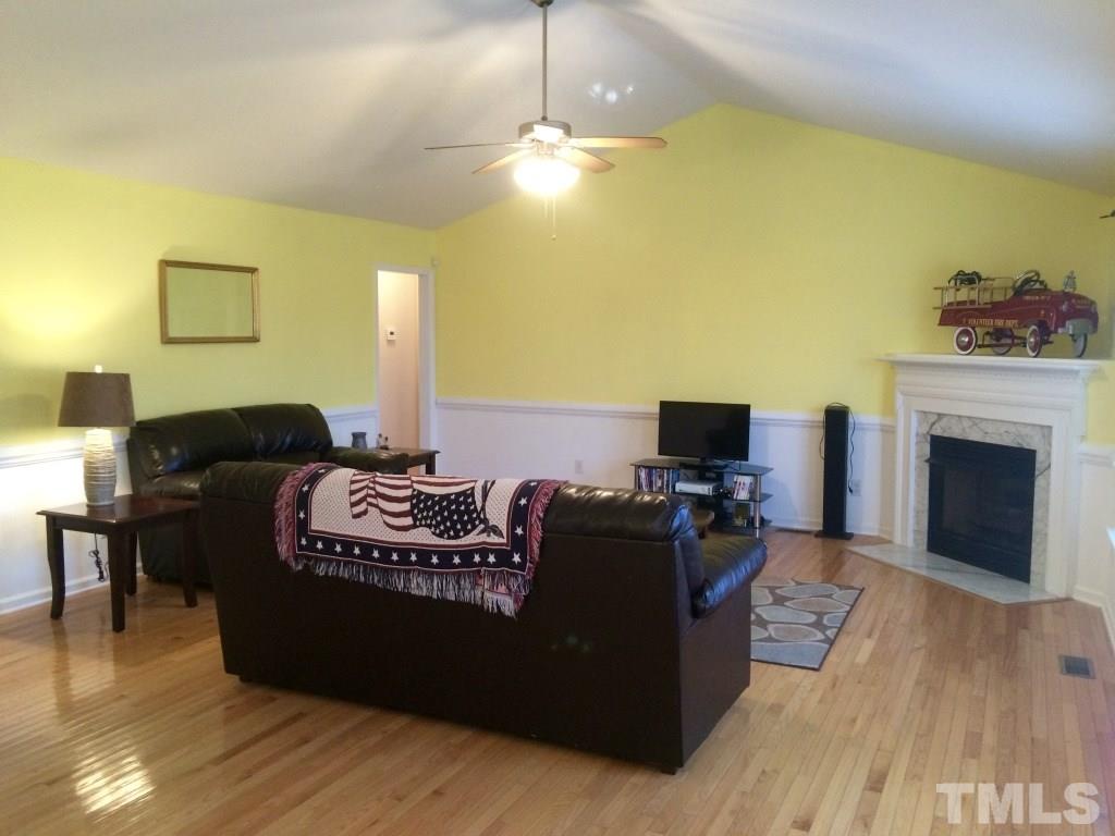 258 Wagner Road Willow Spring, NC 27592 - Photo 5 of 22 a living room with furniture and a fireplace