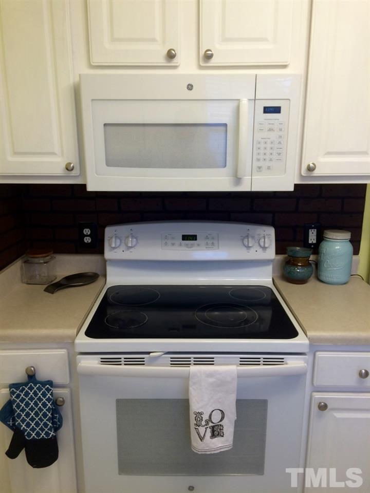 258 Wagner Road Willow Spring, NC 27592 - Photo 9 of 22 a stove top oven sitting inside of a kitchen