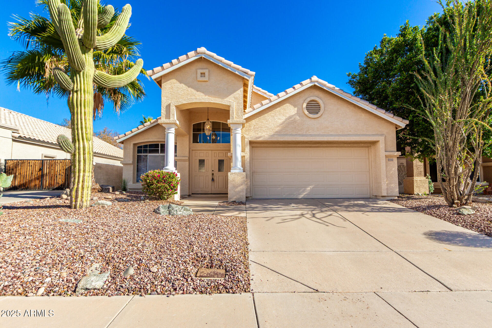 16617 South 14th Street Phoenix, AZ 85048 - Photo 1 of 26 a front view of a house with a yard and garage