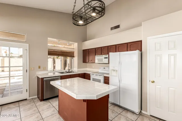 a kitchen with stainless steel appliances a sink stove and refrigerator