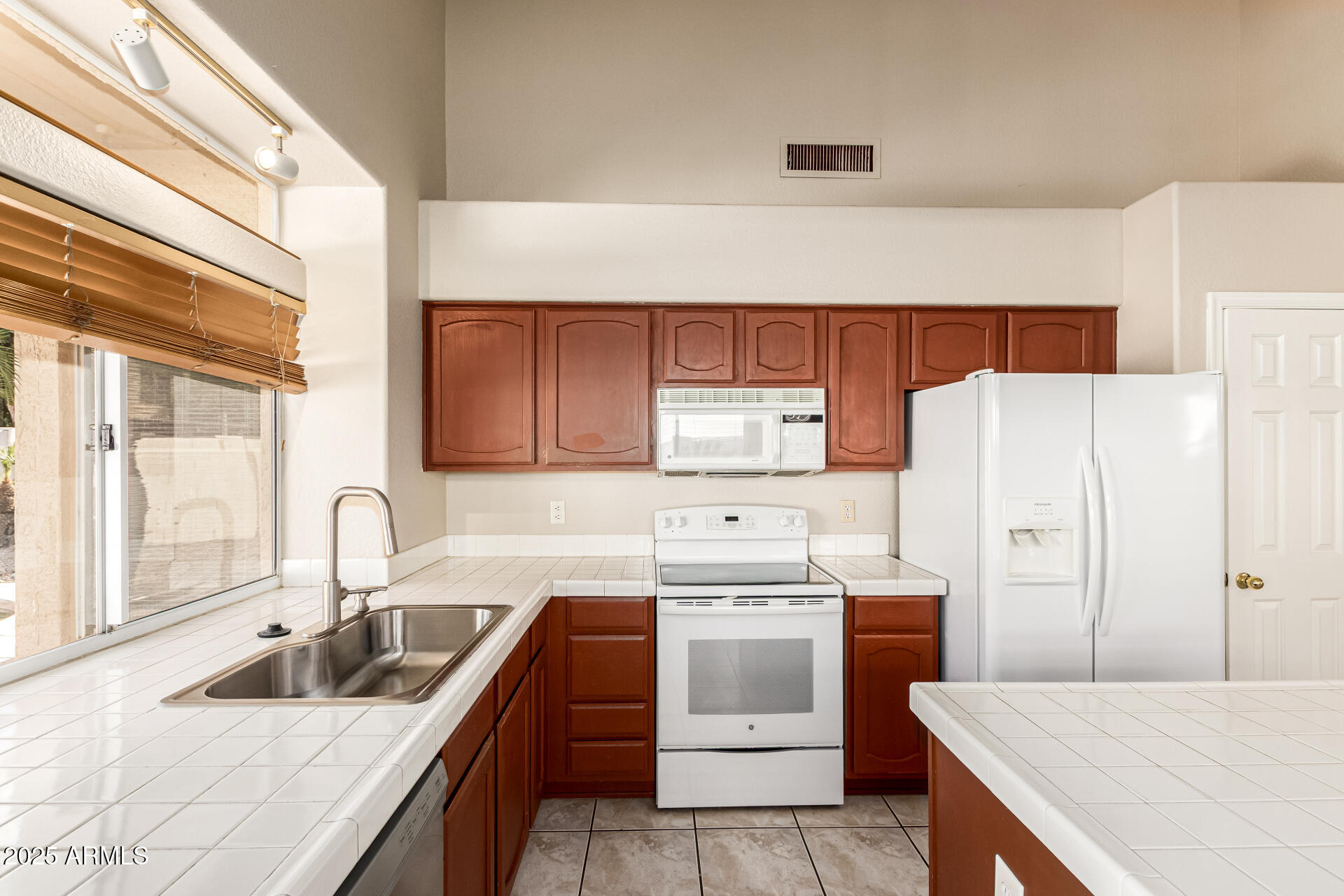 16617 South 14th Street Phoenix, AZ 85048 - Photo 11 of 26 a kitchen with a sink a stove and refrigerator