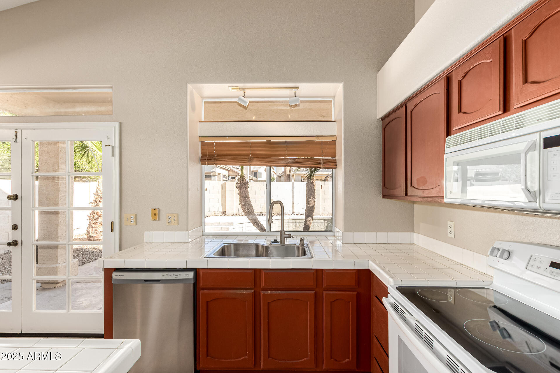 16617 South 14th Street Phoenix, AZ 85048 - Photo 12 of 26 a kitchen with a sink stove and cabinets