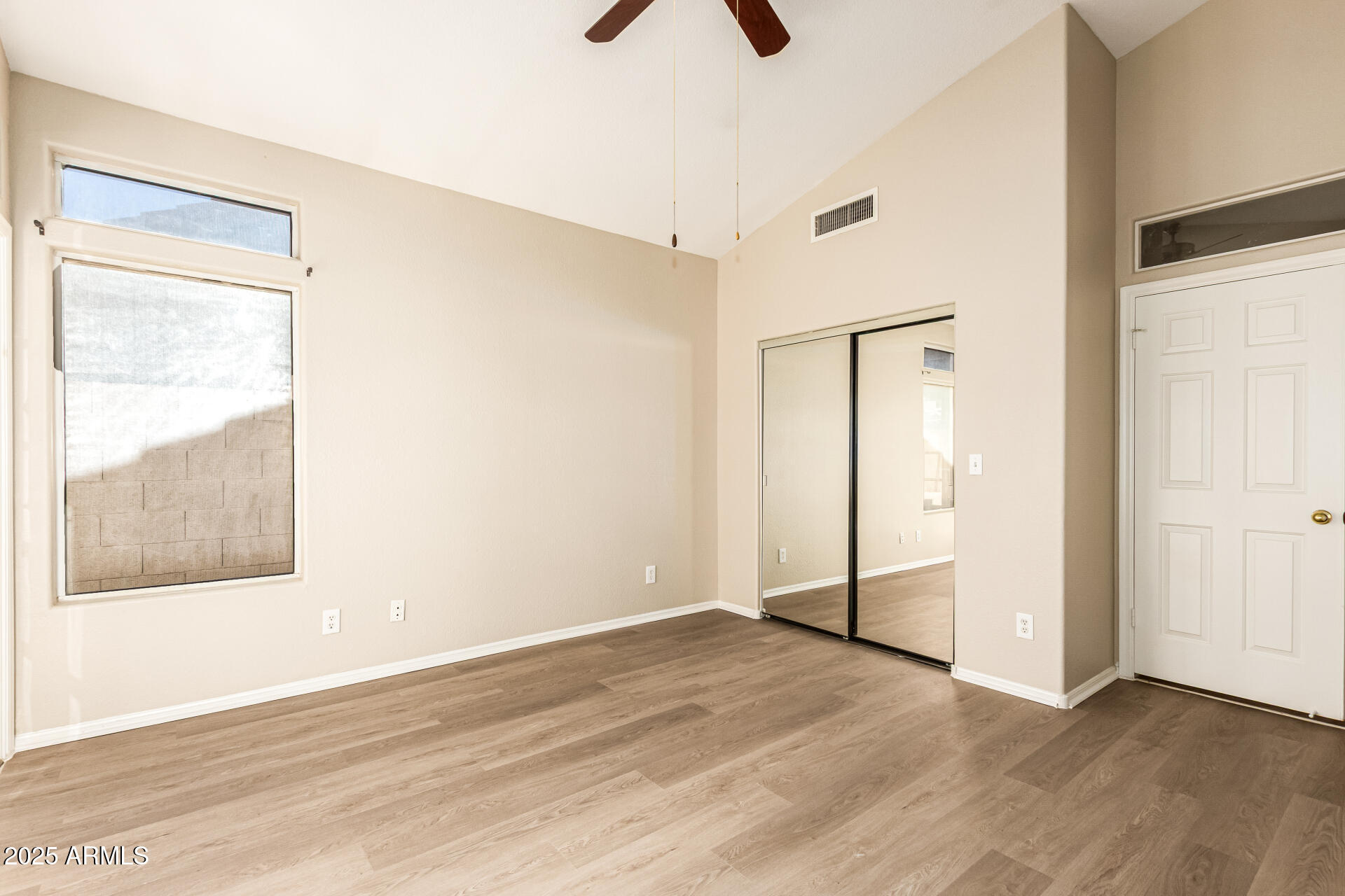 16617 South 14th Street Phoenix, AZ 85048 - Photo 14 of 26 an empty room with wooden floor and a ceiling fan