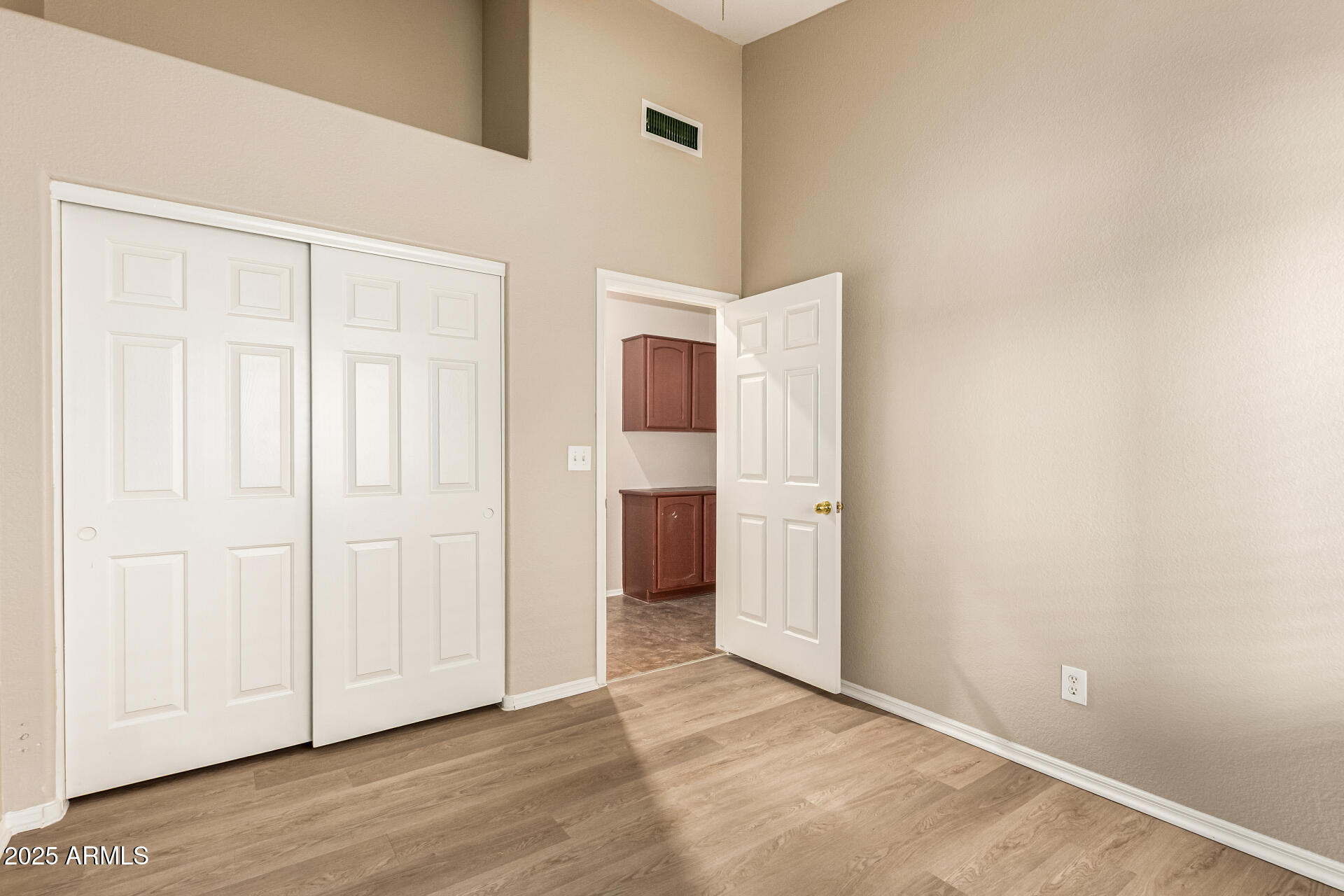 16617 South 14th Street Phoenix, AZ 85048 - Photo 18 of 26 an empty room with wooden floor and closet