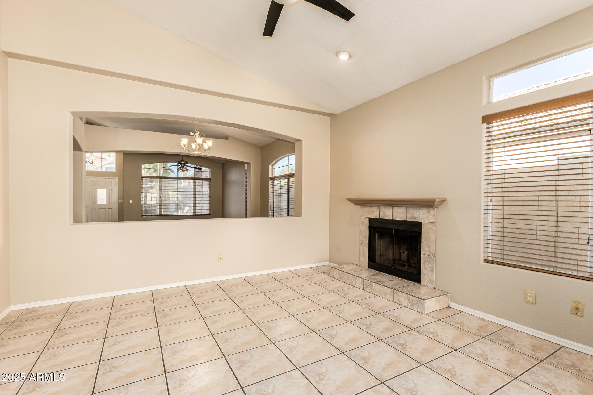 16617 South 14th Street Phoenix, AZ 85048 - Photo 6 of 26 a view of an empty room with a fireplace and a window
