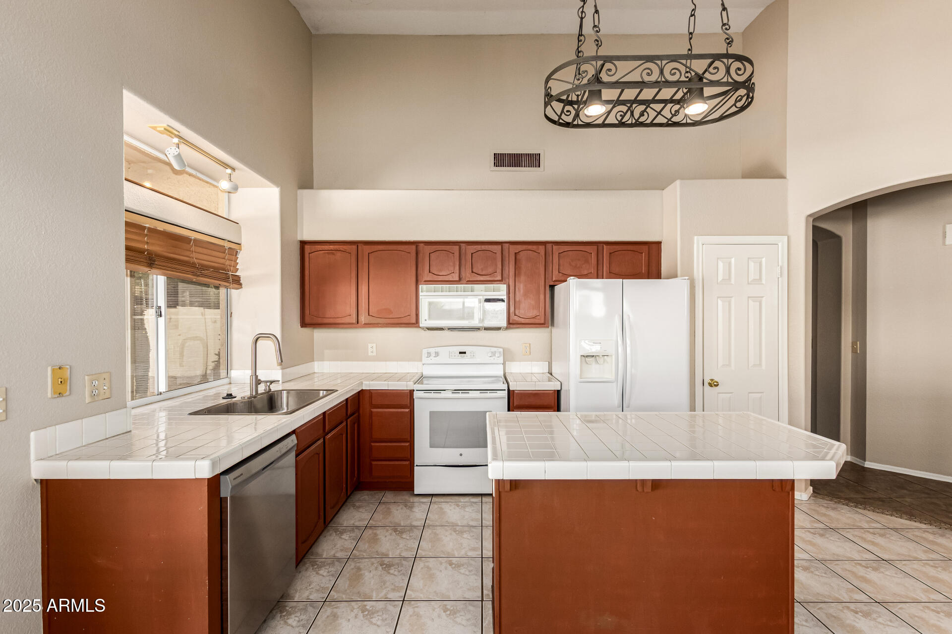 16617 South 14th Street Phoenix, AZ 85048 - Photo 9 of 26 a kitchen with stainless steel appliances a sink stove and refrigerator
