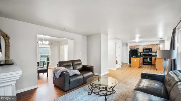 a living room with furniture and kitchen view