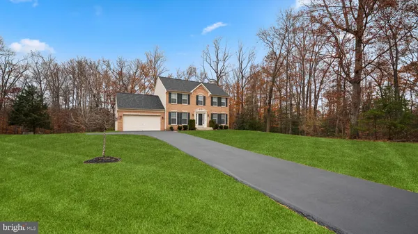 a house with green field in front of it