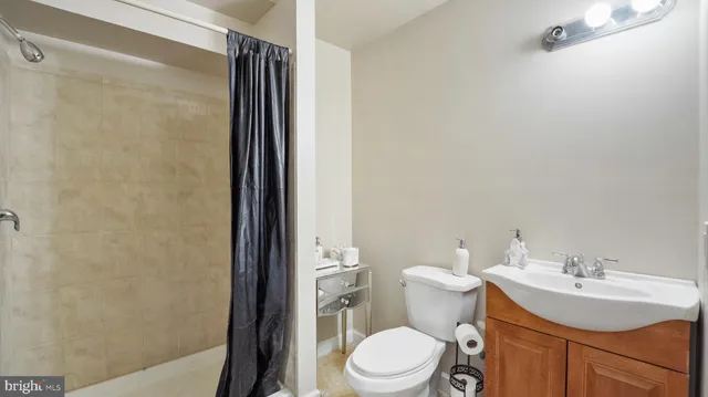 a bathroom with a sink toilet and shower