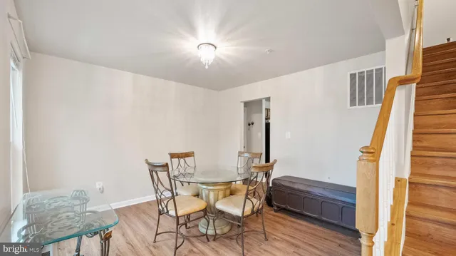 a view of a dining room with furniture and wooden floor