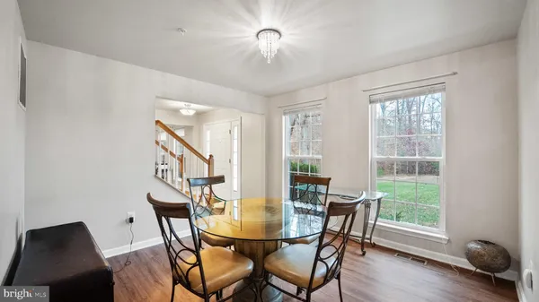 a view of a dining room with furniture window and wooden floor