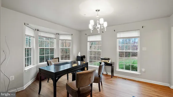 a view of a dining room with furniture wooden floor and chandelier