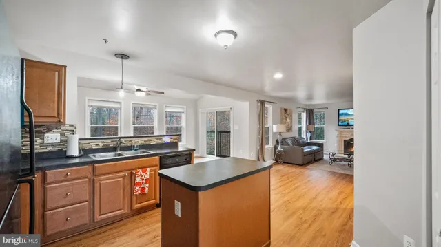 a large kitchen with sink a refrigerator and cabinets