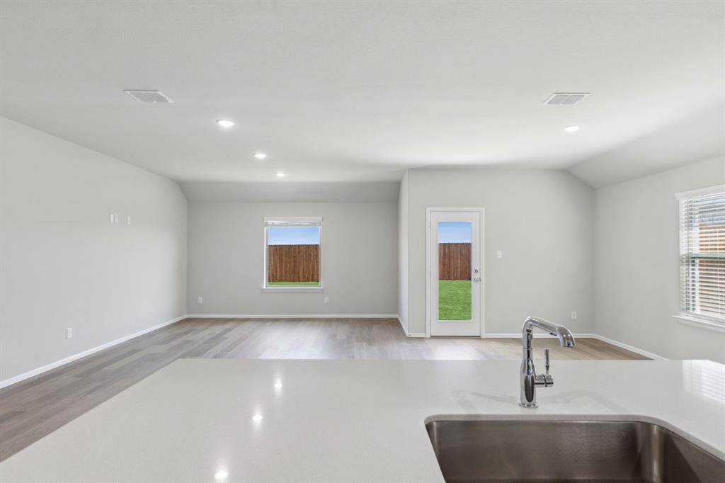 7620 Kingfisher Road Aubrey, TX 76227 - Photo 13 of 32 a bathroom with a sink and a large mirror