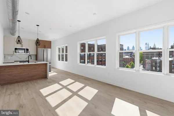 a living room with furniture and large window