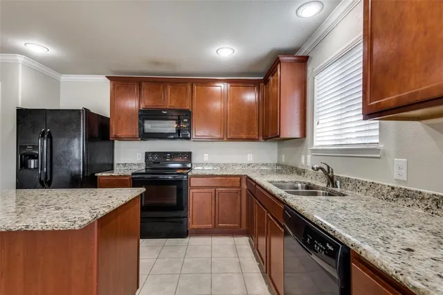 a kitchen with stainless steel appliances granite countertop a sink stove and cabinets