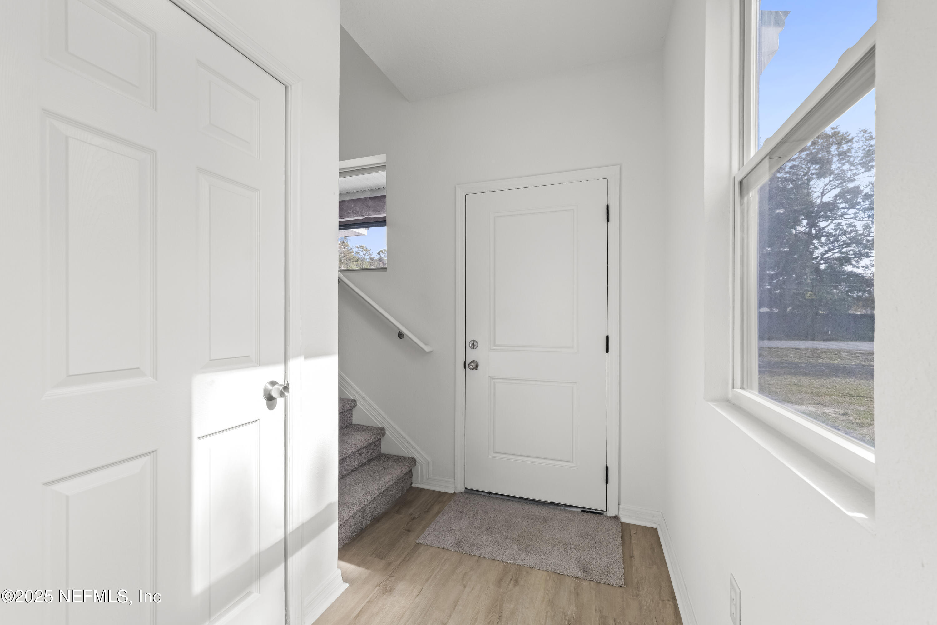 12476 Gate Road Jacksonville, FL 32226 - Photo 13 of 29 a view of a hallway with wooden floor and entryway