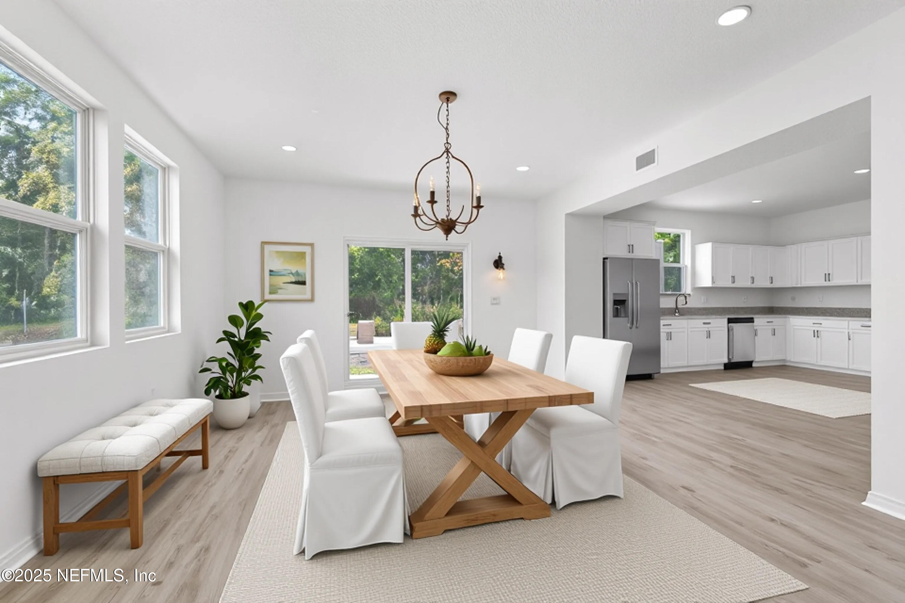 12476 Gate Road Jacksonville, FL 32226 - Photo 2 of 29 a dining room with furniture a chandelier and wooden floor