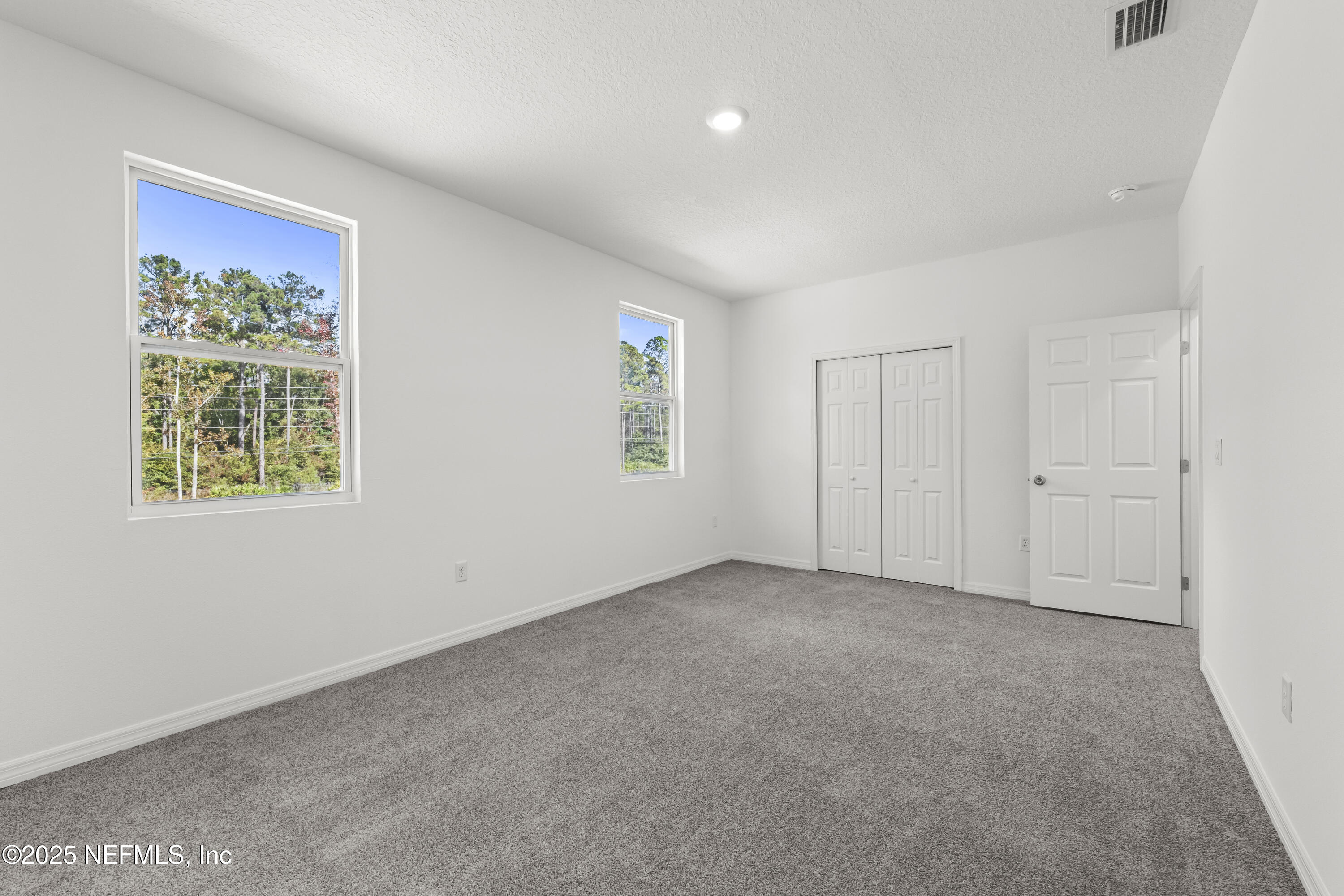 12476 Gate Road Jacksonville, FL 32226 - Photo 23 of 29 an empty room with windows