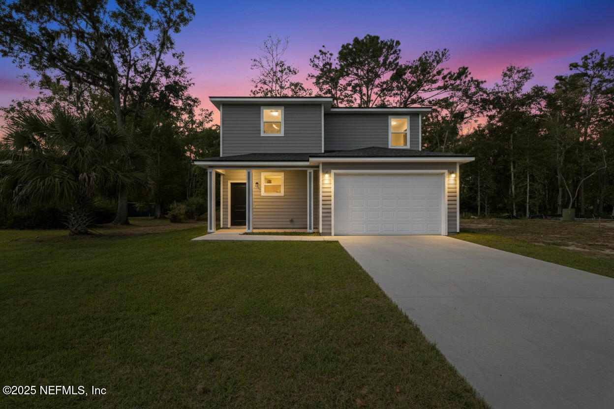 12476 Gate Road Jacksonville, FL 32226 - Photo 24 of 29 a front view of a house with a yard and a garage