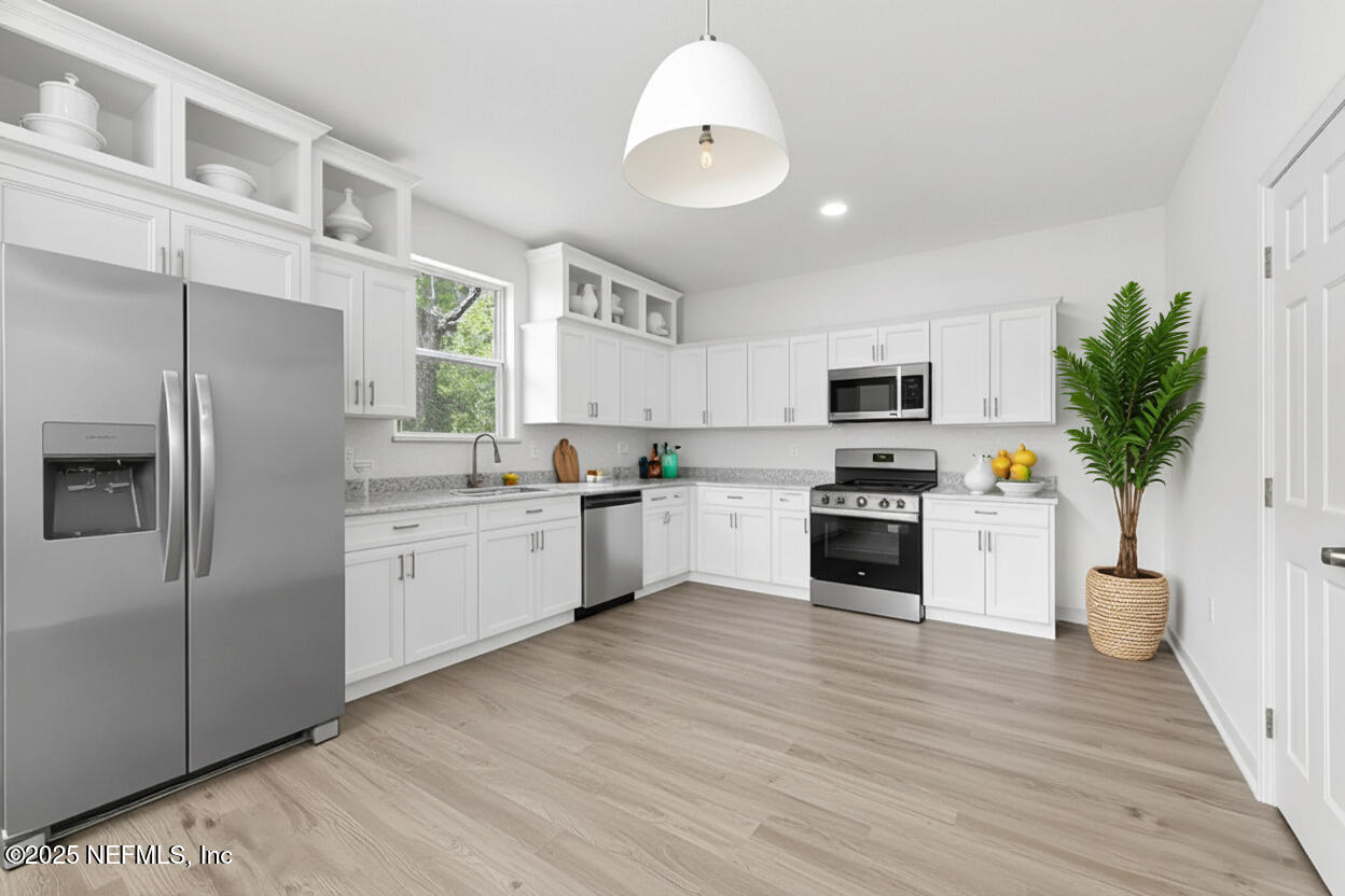 12476 Gate Road Jacksonville, FL 32226 - Photo 3 of 29 a kitchen with white cabinets and white appliances
