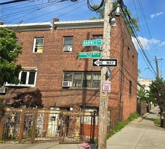 a view of a brick building next to a road