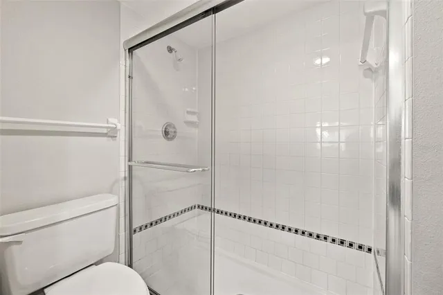 a bathroom with a shower and toilet