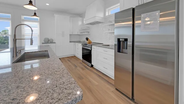 a bathroom with a granite countertop double vanity sink toilet and shower